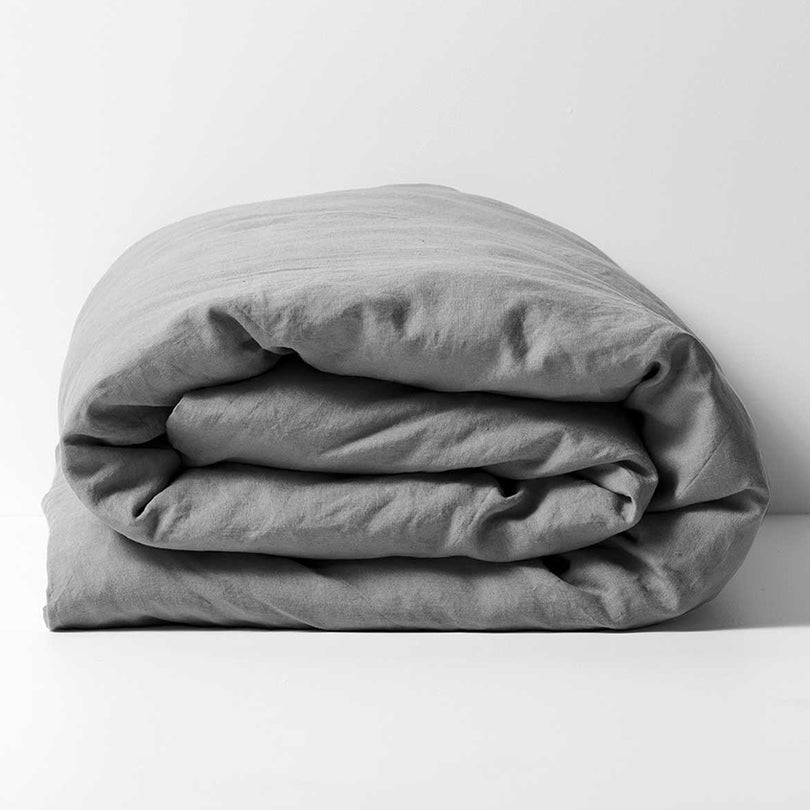 Emile linen quilt cover in Smoke styled on a bed