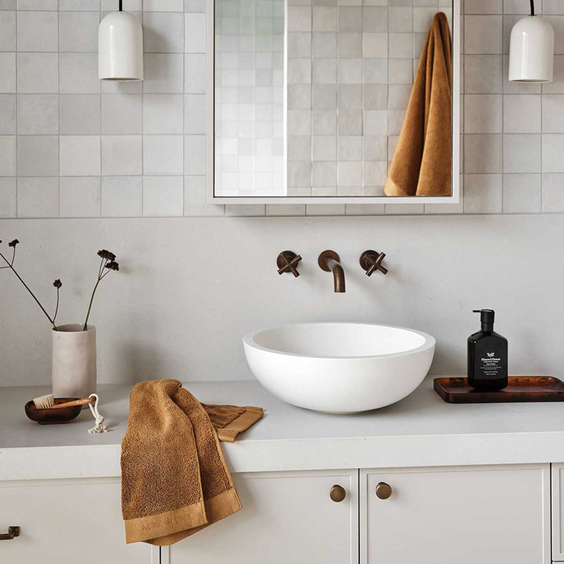 Aura Haven bronze bath towels in a contemporary bathroom