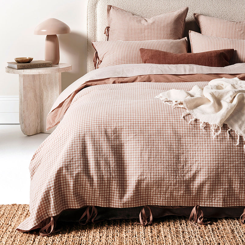 A generously sized quilt draped over a beautifully styled bed