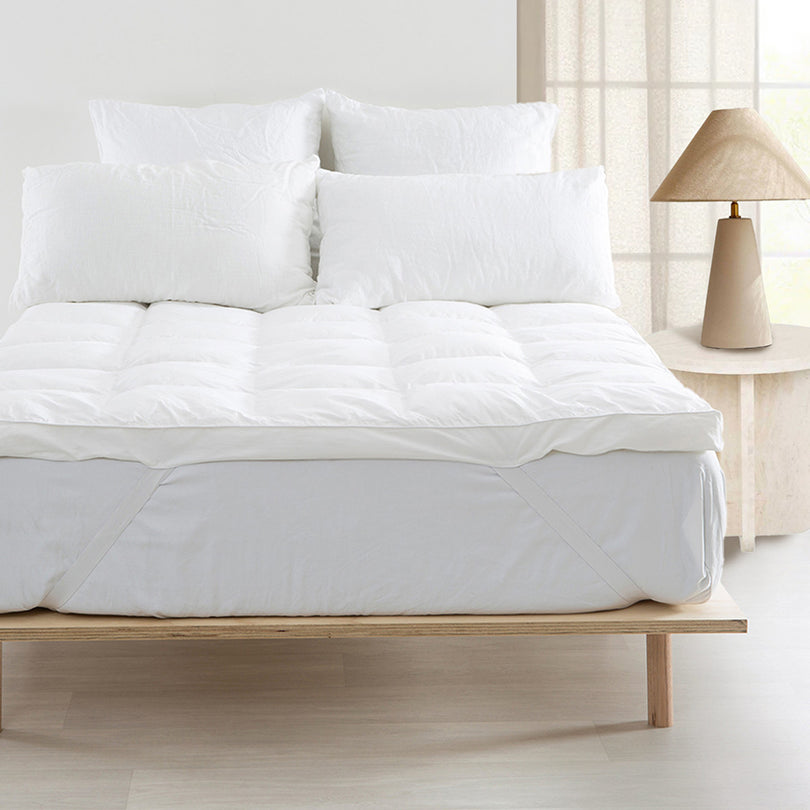 Hotel-style mattress topper adding comfort to a bed