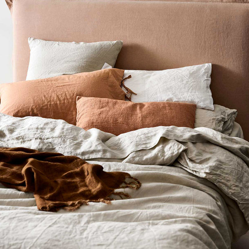 Layered Emile linen bedding showing quilt cover, sheets, pillowcases and coverlet